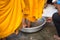 Queue of barefoot monks with foot wash ceremonial in south of Vietnam