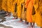 Queue of barefoot monks with foot wash ceremonial in south of Vietnam