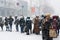 Queue at a bus stop under unexpected snow