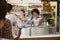 A queue of customers served by two women at a sandwich bar