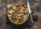 Quiche with kale, chicken, zucchini, sweet pepper, ham, mozzarella cheese on a wooden cutting board, top view. Delicious snack,