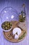 A quick healthy snack. Bread with hermelin cheese, camembert, olives on a round wooden board with a lid.