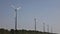 Quick motion video of row of wind farms in the field