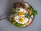 A quick nutritious Breakfast of sandwiches with scrambled eggs on fresh lettuce leaves in a round plate,