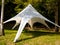 Quickly erected fabric tent in a forest glade