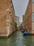 Quiet back canal with moored boats, Venice, Italy