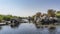 A quiet backwater on the river. Picturesque boulders and green vegetation on the banks.