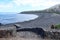 The quiet beach of La Caleta with volcanic black sand in the Atlantic ocean, perfect for relaxing. Caleta de Interian, Tenerife, S