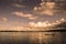 Quiet calm lake sunset with silhouette fisherman with boat