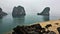 Quiet and calm landscape in Halong Bay. Large stones lie on the sandy beach.