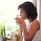 Quiet contemplation over coffee. a young woman drinking a beverage at home.