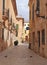 Quiet empty picturesque cobbled narrow street in ciutadella menorca with balconies and street lamps on colorful old houses