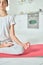 Quiet mind. Cropped shot of relaxed hispanic teenage girl in sportswear practicing yoga, meditating on a mat in the