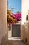 A quiet narrow street in Emporeio village, Santorini, Greece. Bougainvillea flowers in bloom