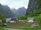 Quiet Norwegian village in spring at the foot of the mountains on the shore of the fjord