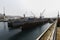 A quiet passage stands on the water in Slavyanka Bay with a ship being repaired in it.