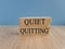 Quiet quitting symbol. Concept words Quiet quitting on brick blocks.