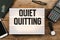 Quiet Quitting text headline in vintage style light box on office deskt op