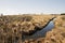 A quiet river among fields. Autumn landscape. Dried grain.