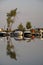 Quiet warm autumn evening in the port. Yachts at the pier. Reflection in water