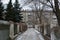 Quiet winter snowy streets, nooks and crannies of the street with houses, high fences in the city of Dnipro, Ukraine.