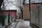 Quiet winter snowy streets, nooks and crannies of the street with houses, high fences in the city of Dnipro, Ukraine.