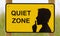 Quiet zone sign, yellow with a black silhouette