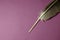 Quill pen on purple background