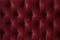 Quilted velour buttoned burgundy red color fabric wall pattern background. Elegant vintage luxury sofa upholstery. Interior plush