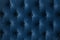 Quilted velour buttoned classic blue color fabric wall pattern background. Elegant vintage luxury sofa upholstery. Interior plush