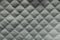 Quilted white fabric with diamond pattern from above