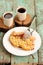 Quince crumble pie and coffee on handmade wooden stands