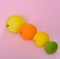 Quince orange lime lemon on a pink background