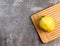 Quince on a rectangular cutting wooden board on a dark background