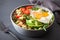 Quinoa bowl with fried egg, avocado, tomato, rocket. Healthy veg