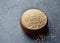 Quinoa in a brown wooden bowl on dark stone background. Dry uncooked cereal grains, cooking ingredient