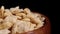 Quinoa cereal gluten free flakes in rustic wooden bowl. Dry crunchy vegetable grain breakfast