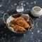 Quinoa crusted chicken in a metal bowl.