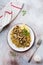 Quinoa, fried mushrooms and lemon for wholesome meal served in simple ceramic plate.