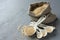 Quinoa grain in small burlap sack and porcelain measuring spoons