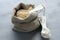 Quinoa grain in small burlap sack and porcelain measuring spoons