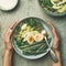 Quinoa, kale, green beans, avocado, egg bowls flat-lay, square crop