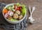 Quinoa meatballs and vegetable salad. Buddha bowl on a wooden table, top view. Healthy, diet, vegetarian food concept.