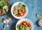 Quinoa with pumpkin, spinach and avocado. Healthy quinoa bowl. On a blue background, top view.