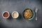 Quinoa salad bowl with colorful vegetables: green beans, carrot, corn, bell pepper, peas and two cups with red and white quinoa se