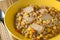 Quinoa with tofu and sweet corn in a yellow bowl