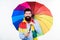 Quite useful for keeping him dry. Rain man. Bearded man with colorful umbrella. Colorful person holding open umbrella