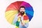 Quite useful for keeping him dry. Rain man. Bearded man with colorful umbrella. Colorful person holding open umbrella