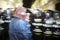 Quito, Ecuador - August 27, 2015: Man wearing denim jacket and face covered standing in front of police shields protesting