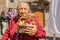 Quito, Ecuador - January 11, 2018: Close up of old woman holding in her hands a straw basket with some crafts, during a